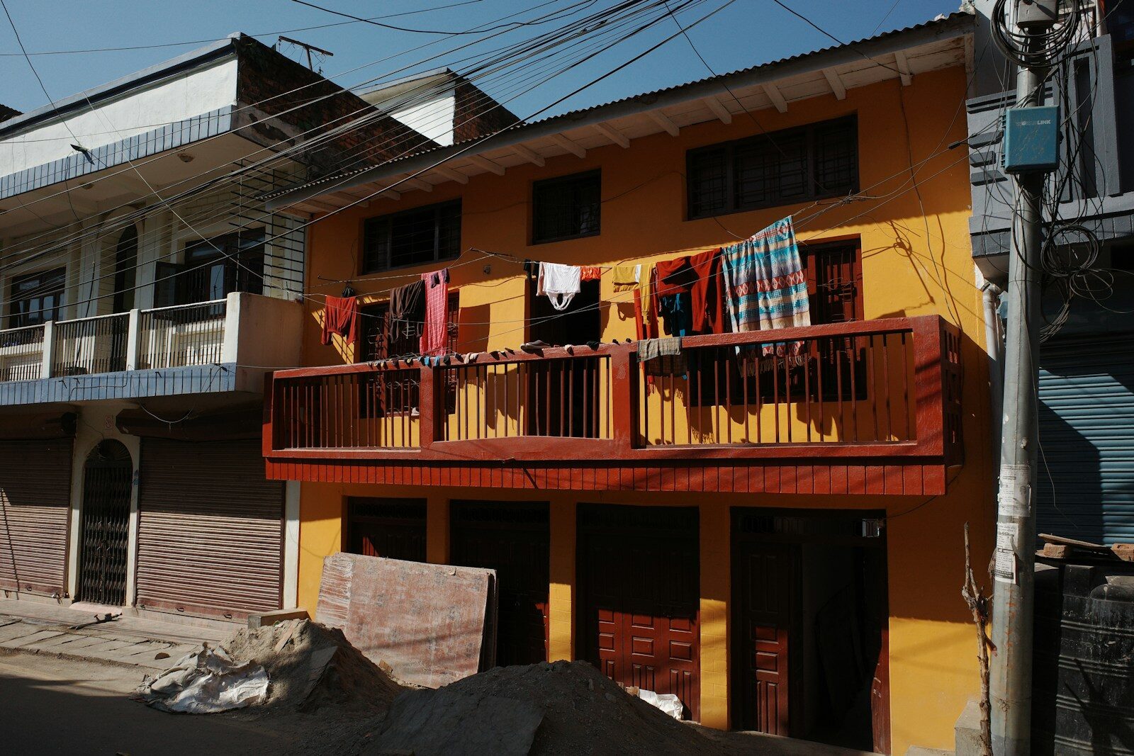 Yellow building with clothes drying on balcony