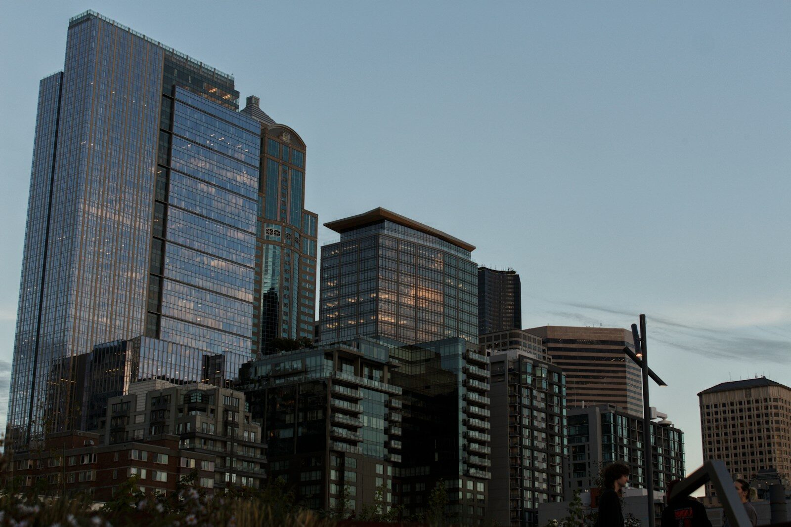Modern skyscrapers against a clear sky at dusk.