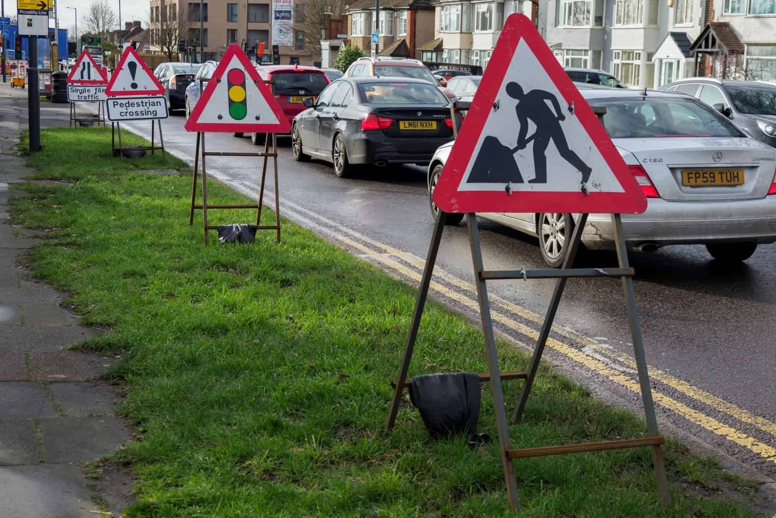 Photo by Brett Jordan white and red arrow sign on green grass field