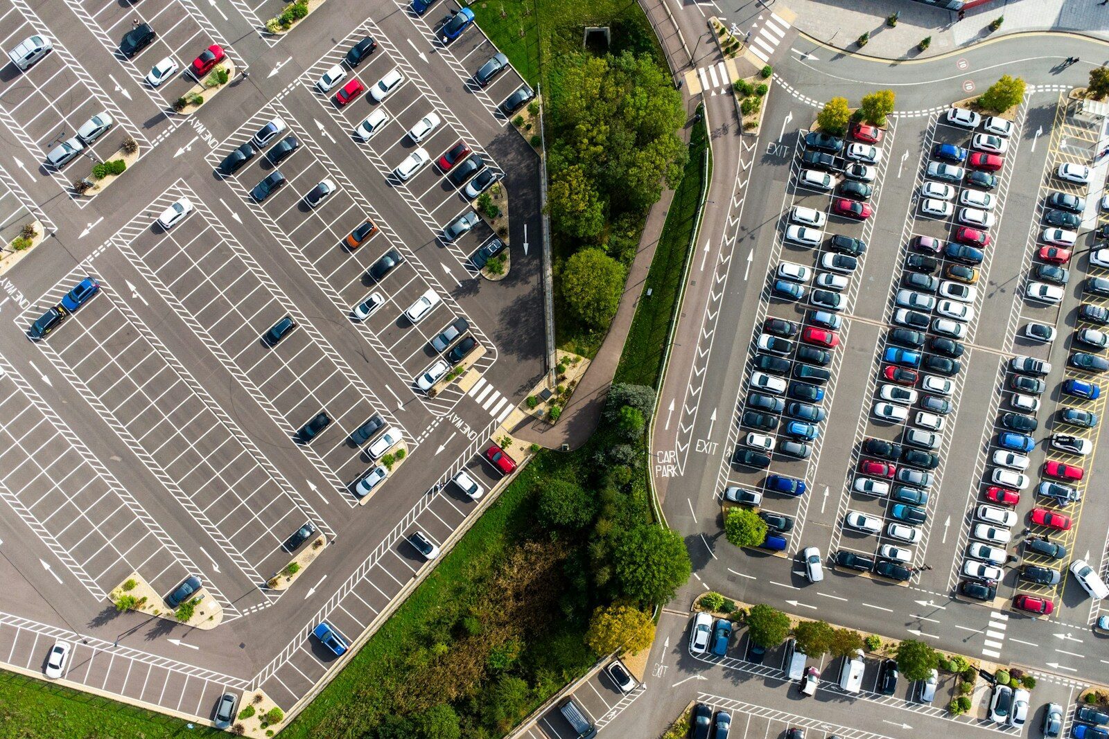 an aerial view of a parking lot with cars parked in it