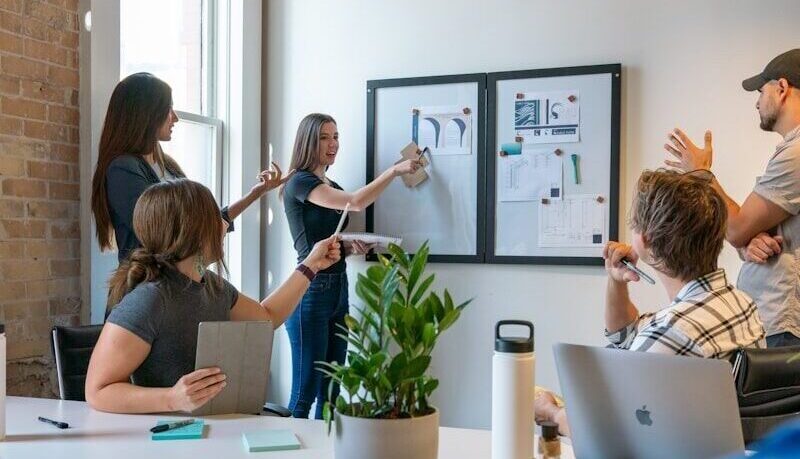 a group of people sitting around a white table